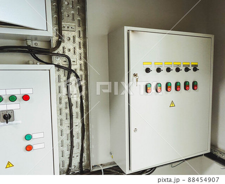 Electrical room of residential or commercial building. Multiple smart meters, main power breaker, meter stacks and cabinets. Perspective view. Electrical room of residential or commercial building. Multiple smart meters, main power breaker, meter stacks and cabinets. Perspective view. 88454907