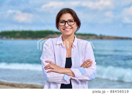 Outdoor portrait of mature smiling woman on sea vacation Outdoor portrait of mature smiling woman on sea vacation 88456019
