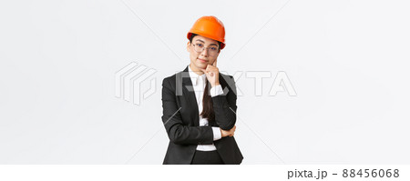 Smiling professional asian businesswoman invest money in construction, manage work at enterprise, wearing safety helmet and suit, looking pleased at camera, standing white background Smiling professional asian businesswoman invest money in construction, manage work at enterprise, wearing safety helmet and suit, looking pleased at camera, standing white background 88456068