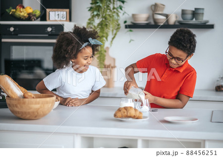 Two kids in the kitchen having breakfast Two kids in the kitchen having breakfast 88456251