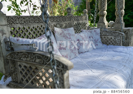 Hanging sofa swing with pillows and bedspread 88456560