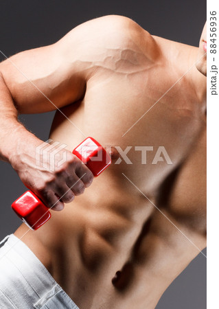 pain relief, sport, bodybuilding, strength and people concept - young man standing over black background pain relief, sport, bodybuilding, strength and people concept - young man standing over black background 88456936