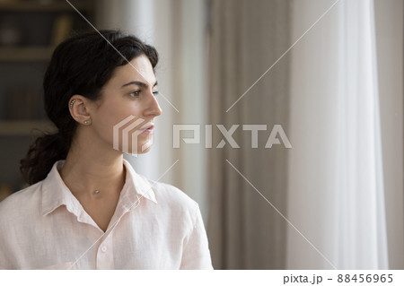 Serious thoughtful millennial Hispanic business woman, entrepreneur looking away Serious thoughtful millennial Hispanic business woman, entrepreneur looking away 88456965