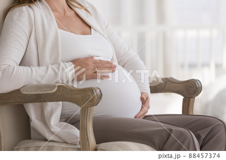 Late pregnant woman big baby bump close up Late pregnant woman big baby bump close up 88457374