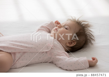 Peaceful calm sleepy cute baby girl wearing pink bodysuit 88457471
