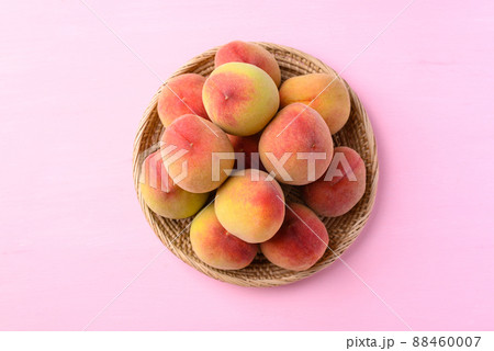 Peach fruit in basket on pink background, Top view Peach fruit in basket on pink background, Top view 88460007