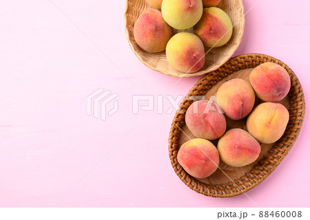 Peach fruit in basket on pink background, Top view Peach fruit in basket on pink background, Top view 88460008