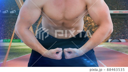 Mid section of caucasian fit man flexing against digital waves and sports field 88463535