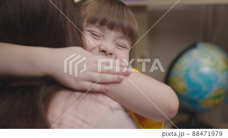 little girl daughter hugs her beloved mother. happy family. childhood dream life. child education of a small kid family. childhood in mother's arms. baby daughter love mommy. parent patronize child 88471979