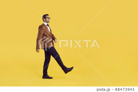 Funny black man in a leopard jacket walking on a yellow copy space studio background Funny black man in a leopard jacket walking on a yellow copy space studio background 88473943