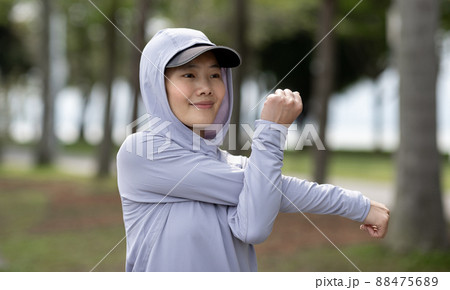 Healthy lifestyle sporty asian woman running at tropical park Healthy lifestyle sporty asian woman running at tropical park 88475689