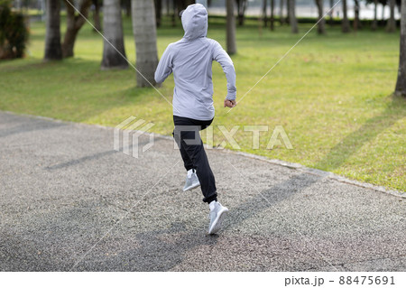 Healthy lifestyle sporty asian woman running at tropical park Healthy lifestyle sporty asian woman running at tropical park 88475691