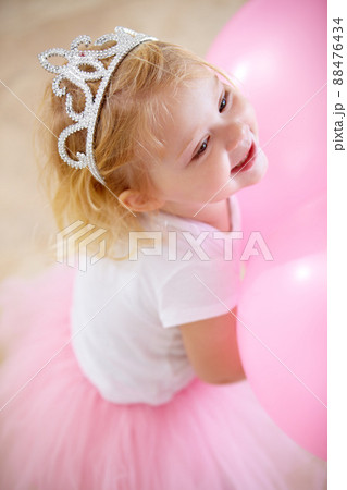 Shes the birthday princess. A little girl dressed up like a princess at her birthday party. Shes the birthday princess. A little girl dressed up like a princess at her birthday party. 88476434