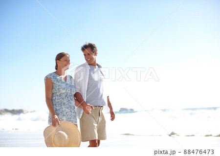 He is just the man that she needs in her life. A happy mature couple walking together on the beach. He is just the man that she needs in her life. A happy mature couple walking together on the beach. 88476473