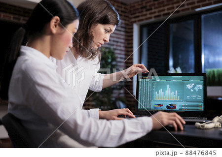Marketing agency employees discussing about bankruptcy while analyzing financial data on laptop screen. Business company office workers sitting at desk while reviewing startup project state. 88476845