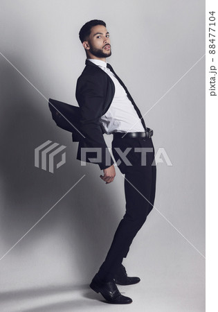 Dodging your negativity. Studio shot of a young man posing against a grey background. Dodging your negativity. Studio shot of a young man posing against a grey background. 88477104