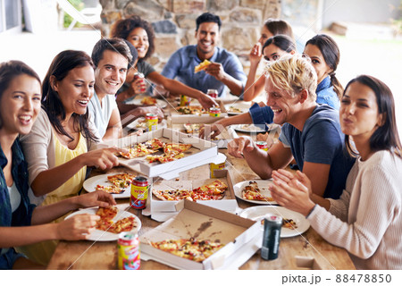 Its time for a pizza party. Cropped shot of a group of friends enjoying pizza together. 88478850