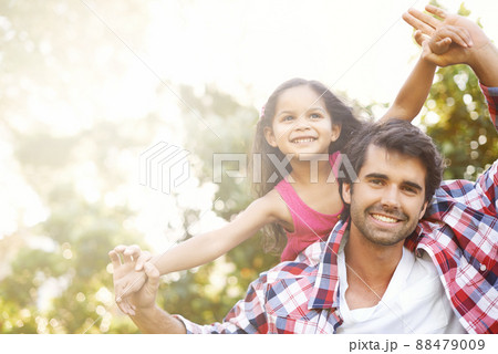 Im always here to lift her up. An attractive young father piggybacking his young daughter with a smile. Im always here to lift her up. An attractive young father piggybacking his young daughter with a smile. 88479009