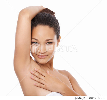 Smooth and silky. Portrait of a beautiful young woman showing her underarm. 88479222