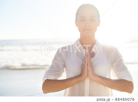 Morning meditating. A beautiful young woman meditating outside. 88480076