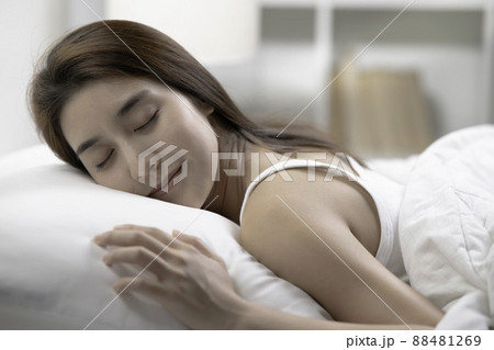 Young beautiful woman sleeping in her bed and relaxing in the morning Young beautiful woman sleeping in her bed and relaxing in the morning 88481269