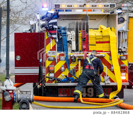 Back of the firetruck with firefighter and equipment Back of the firetruck with firefighter and equipment 88482868