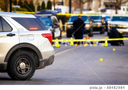 Police car with emergency lights on road with caution tape Police car with emergency lights on road with caution tape 88482984