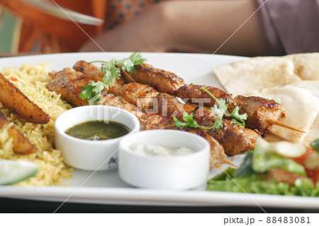 Seekh Kabab, Naan bread, and sauce on a plate Seekh Kabab, Naan bread, and sauce on a plate 88483081
