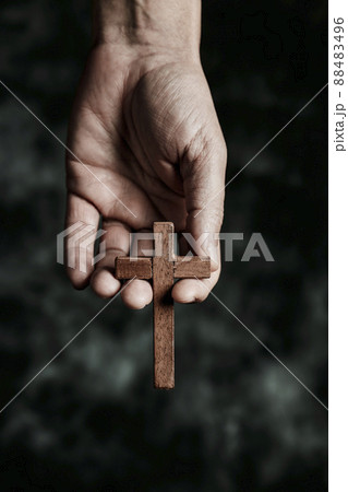 man with a wooden cross in his hand man with a wooden cross in his hand 88483496