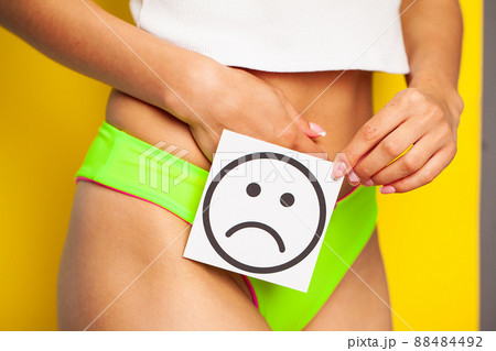 Woman health female body holding white card sad smile near stomach healthy Woman health female body holding white card sad smile near stomach healthy 88484492