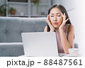 A young woman is stressed from using a computer. 88487561