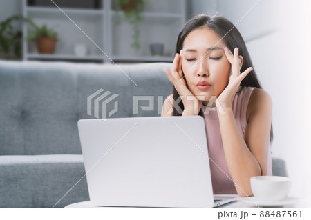 A young woman is stressed from using a computer. 88487561