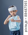 A young girl is practicing fighting and exercising. 88487565