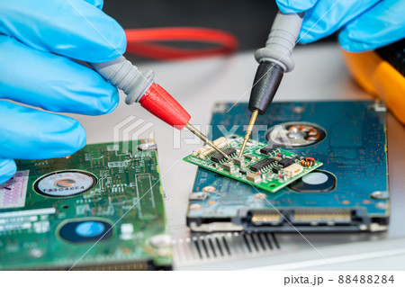 Technician repairing inside of mobile phone by soldering iron. Integrated Circuit. the concept of data, hardware, technology. 88488284
