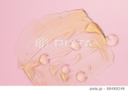 Liquid gel cosmetic product with bubbles on pink background Liquid gel cosmetic product with bubbles on pink background 88489246