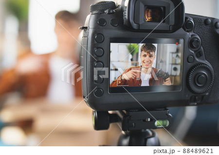 Smiling guy recording video while opening parcel box 88489621
