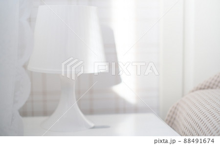 he interior of the room in white tones with a bed, bedside table, table lamp he interior of the room in white tones with a bed, bedside table, table lamp 88491674