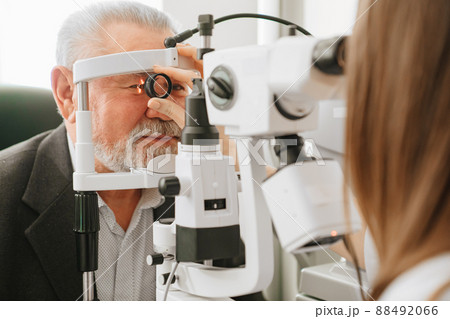 ophthalmologist examination of elderly man with slit lamp. medical equipment 88492066