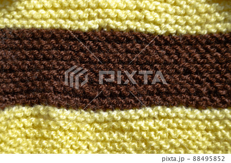 Handmade knitted fabric yellow and brown wool background texture 88495852