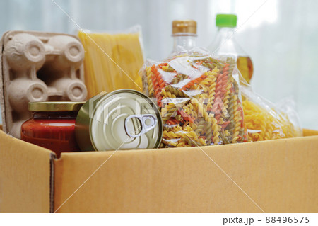 Foodstuffs in donation box for volunteer. Foodstuffs in donation box for volunteer. 88496575