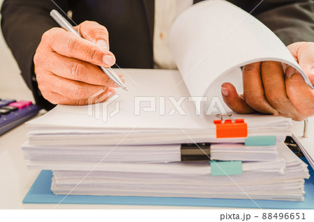 Businessman working and prepare paperwork report data to analysis information in file binder at office. 88496651