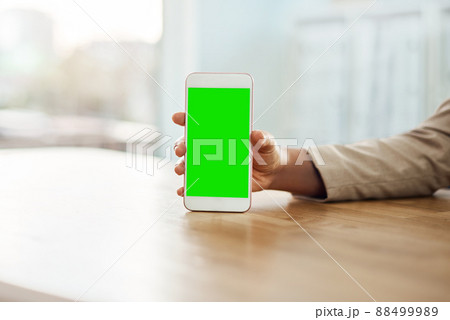 Always stay in the loop. Shot of an unrecognizable businesswoman using a mobile phone in her office. 88499989