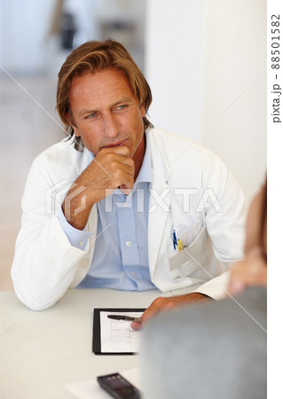 That sounds intriguing. Shot of a man in a lab coat meeting with someone. That sounds intriguing. Shot of a man in a lab coat meeting with someone. 88501582