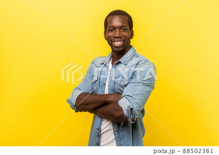 Young happy emotional man on yellow background.looking at camera with toothy smile 88502361