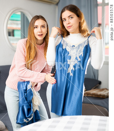 Two young women choosing clothes to wear 88503578