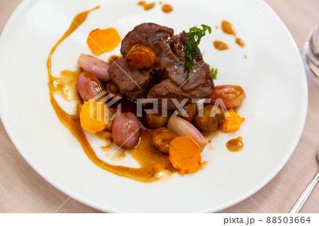 Baked beef fillet with rosemary, shallots, potatoes and chestnuts 88503664