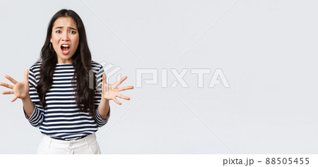 Lifestyle, people emotions and casual concept. Freak-out asian woman in panic, gesturing complaining and looking annoyed, Girl losing temper after touch day at work, having huge trouble 88505455