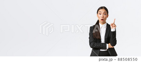 Astounded smart asian female entrepreneur, construction manager have great plan, raising finger up to suggest solution, sharing thoughts and ideas with group, standing white background 88508550