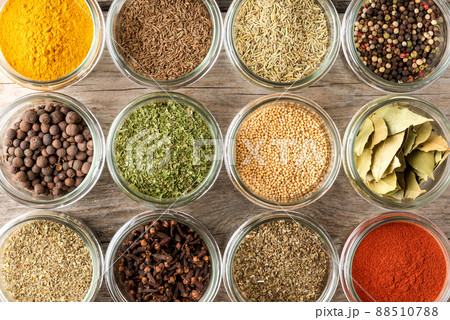 Mix of colourful spices in bowls on wooden table. Collection of seasonings. Top view Mix of colourful spices in bowls on wooden table. Collection of seasonings. Top view 88510788