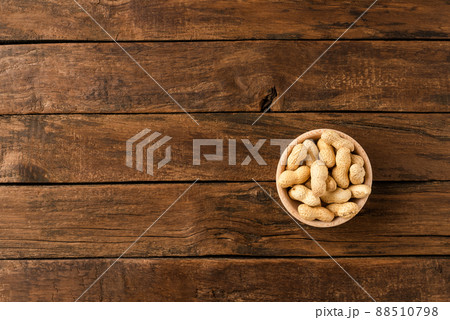 Tasty peanuts in bowl on wooden background with copyspace. Top view Tasty peanuts in bowl on wooden background with copyspace. Top view 88510798